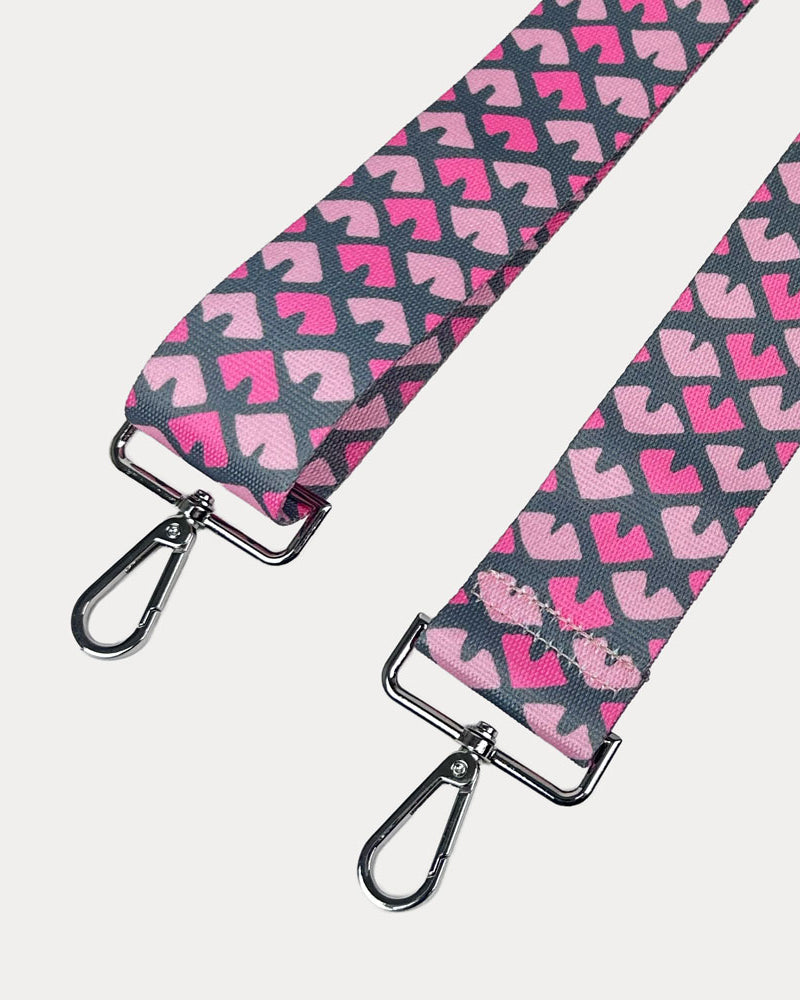 Pink & Grey Patterned strap with silver hardware on a light gray background