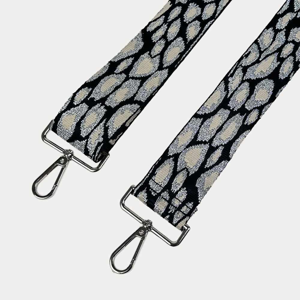 Glitter Leopard strap with silver metal clasps on a light gray background