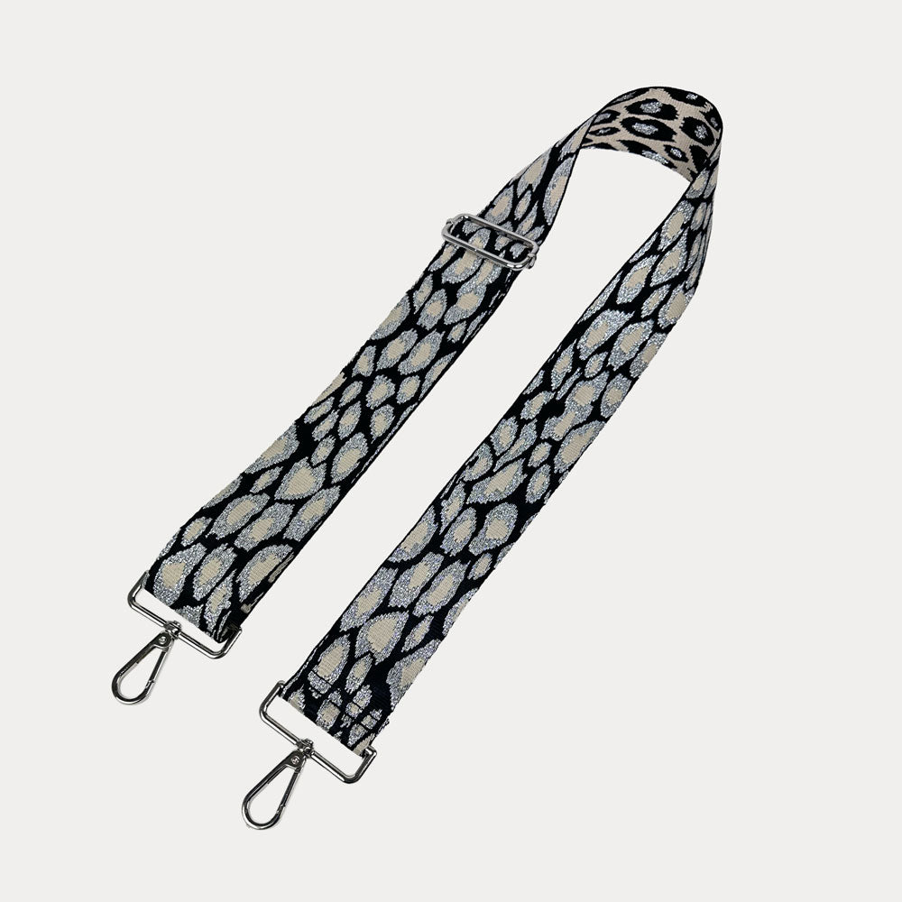 Glitter Leopard print bag strap with Silver metal clasps on a light gray background