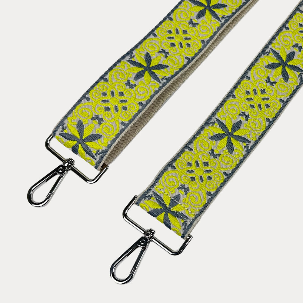 Cream ground with Yellow Floral pattern bag strap with silver metal clasps on a light gray background