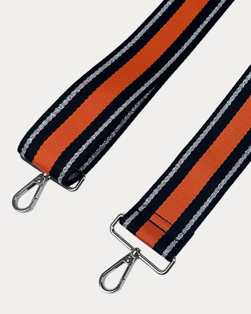 Orange, Navy, and Silver Metallic Striped bag strap with silver hardware on a light gray background