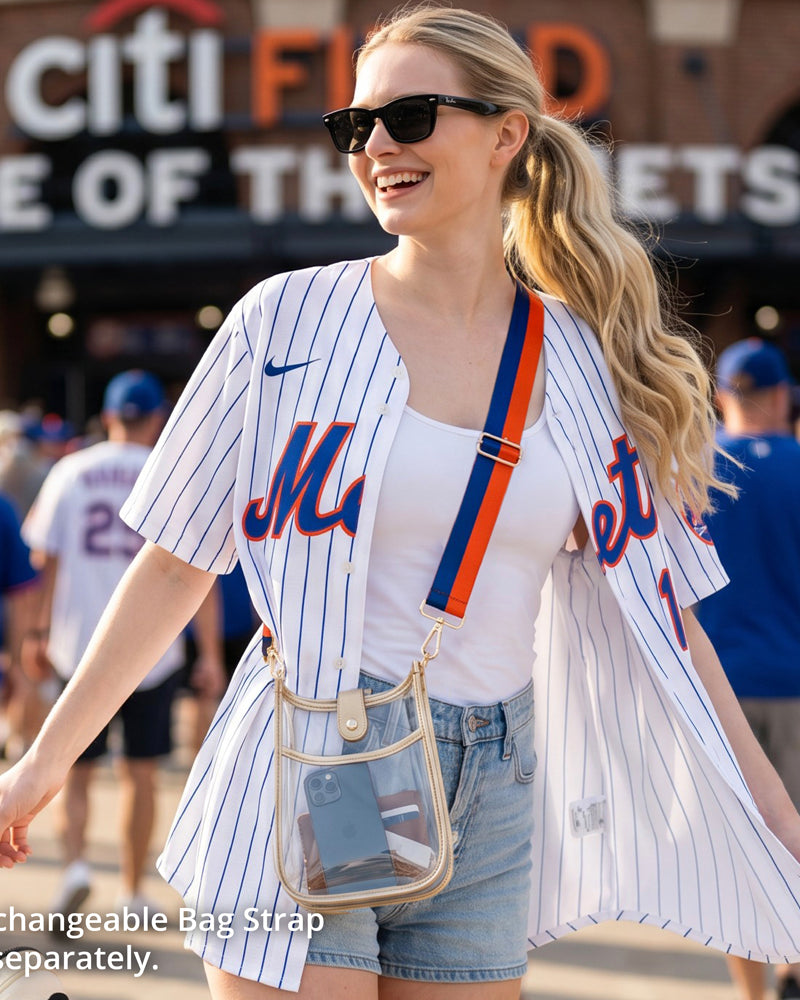 Woman outside a baseball game, wearing a clear messenger bag with a striped bag strap.