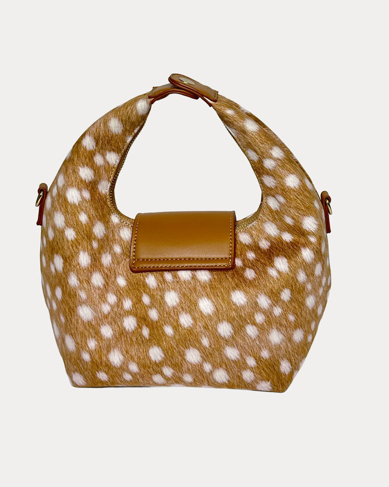 Handbag with deer print and camel leather accents on a light gray background- Back View