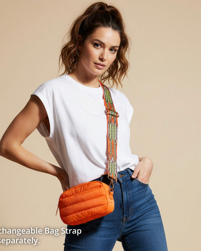 Woman wearing an orange puffer bag with a beige background