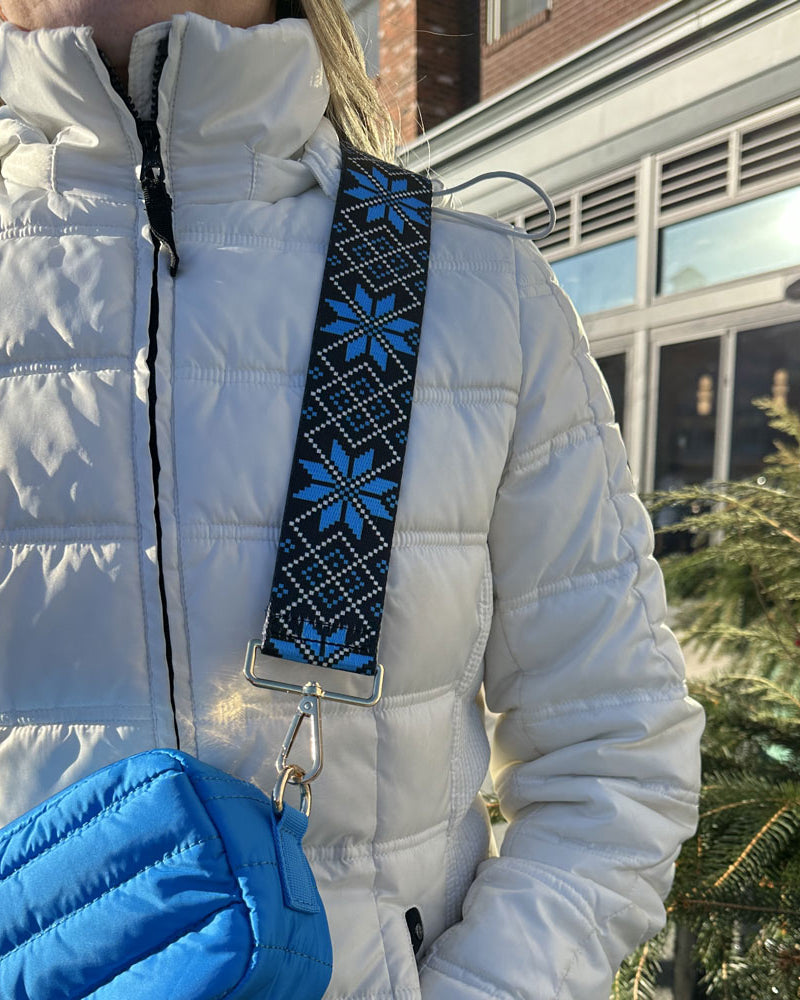 woman wearing printed snowflake bag strap in blue moon