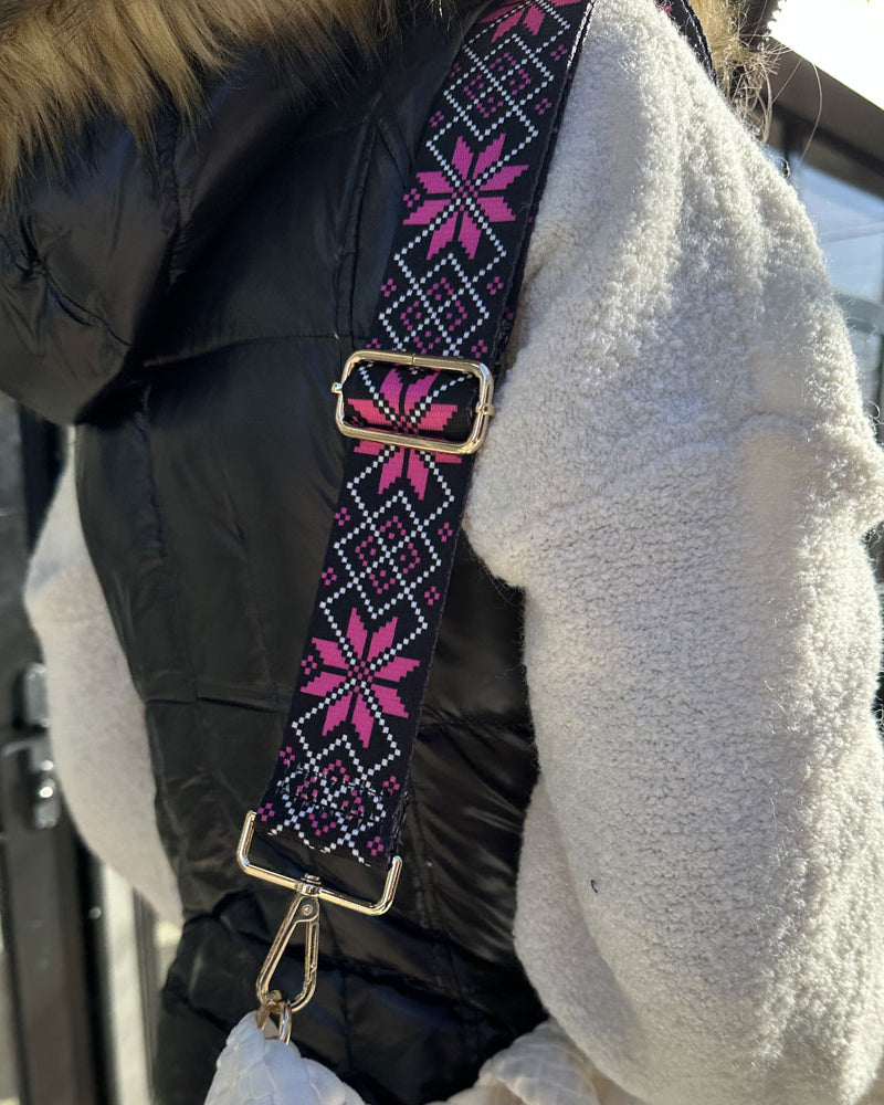 Woman wearing the snowflake printed bag strap in pink