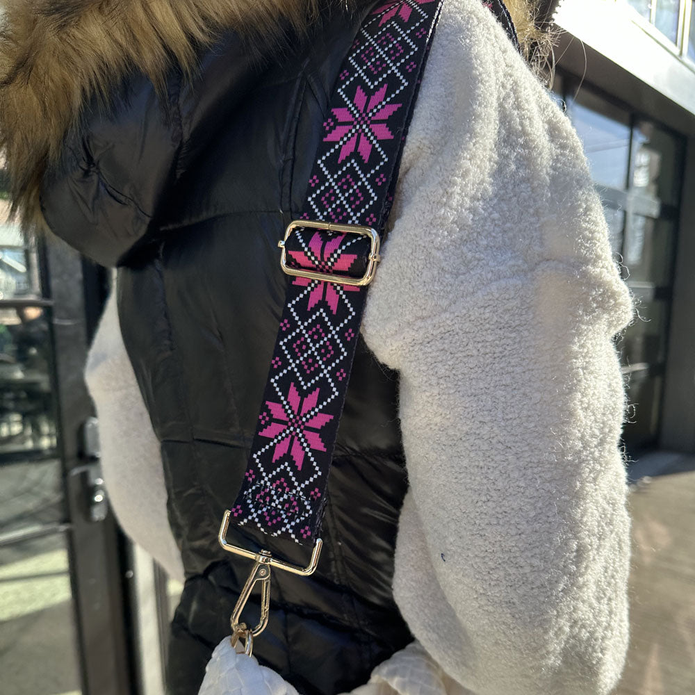 Woman wearing the snowflake printed bag strap in pink