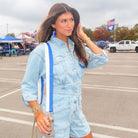 woman wearing royal & white striped game day bag strap with clear game day bag and tailgate