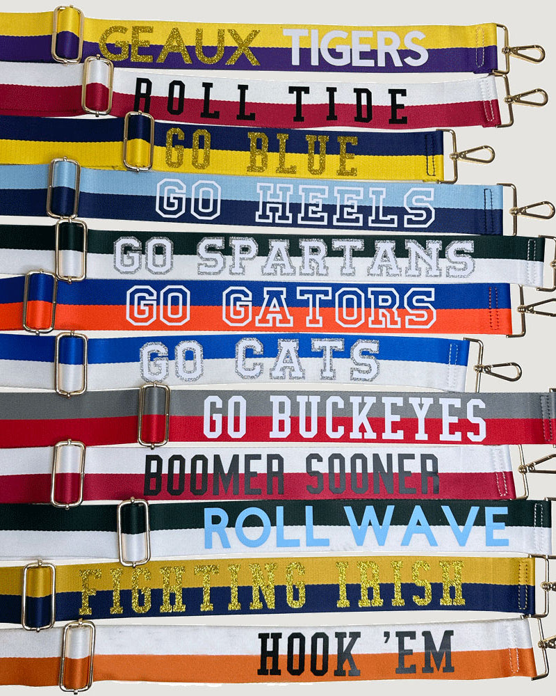 Group of Custom Game Day Bag Straps, text on straps say "Geaux Tigers, Roll Tide, Go Blue, Go Heels, Go Spartans, Go Gators, Go Cats, Go Buckeyes, Boomer Sooner, Roll Wave, Fighting Irish, Hook 'Em"