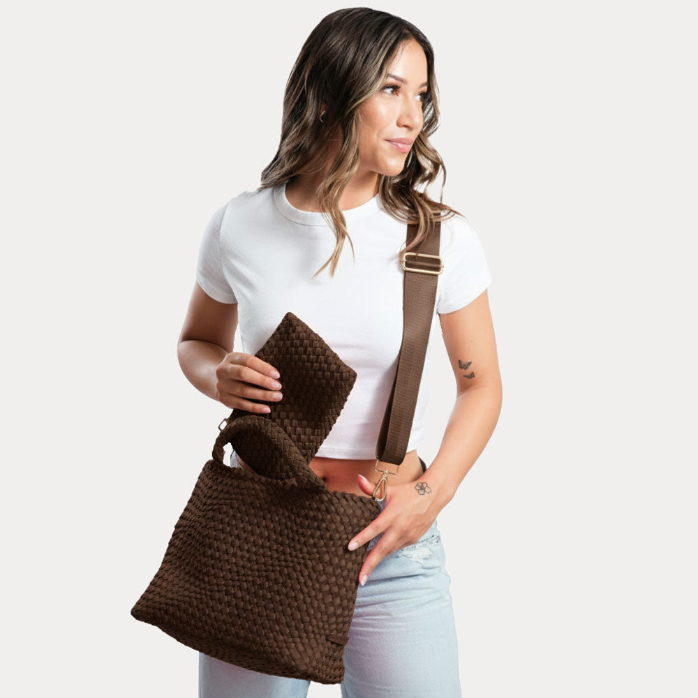 Woman holding a brown woven neoprene tote against a white background