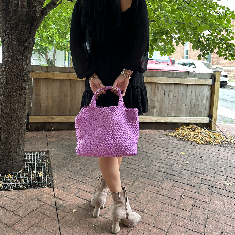 woman holding lily lilac woven neoprene tote at the handles