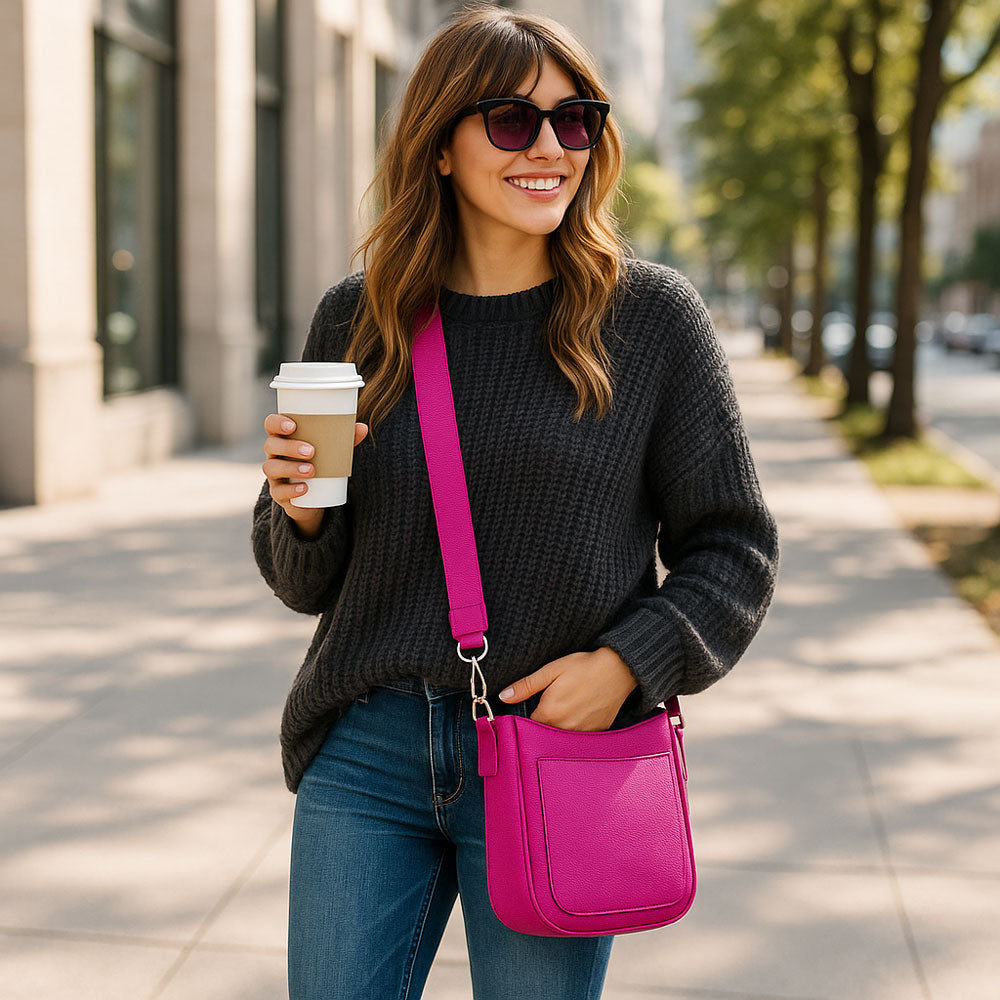 Woman walking outdoors holding a coffee cup and a pink bag