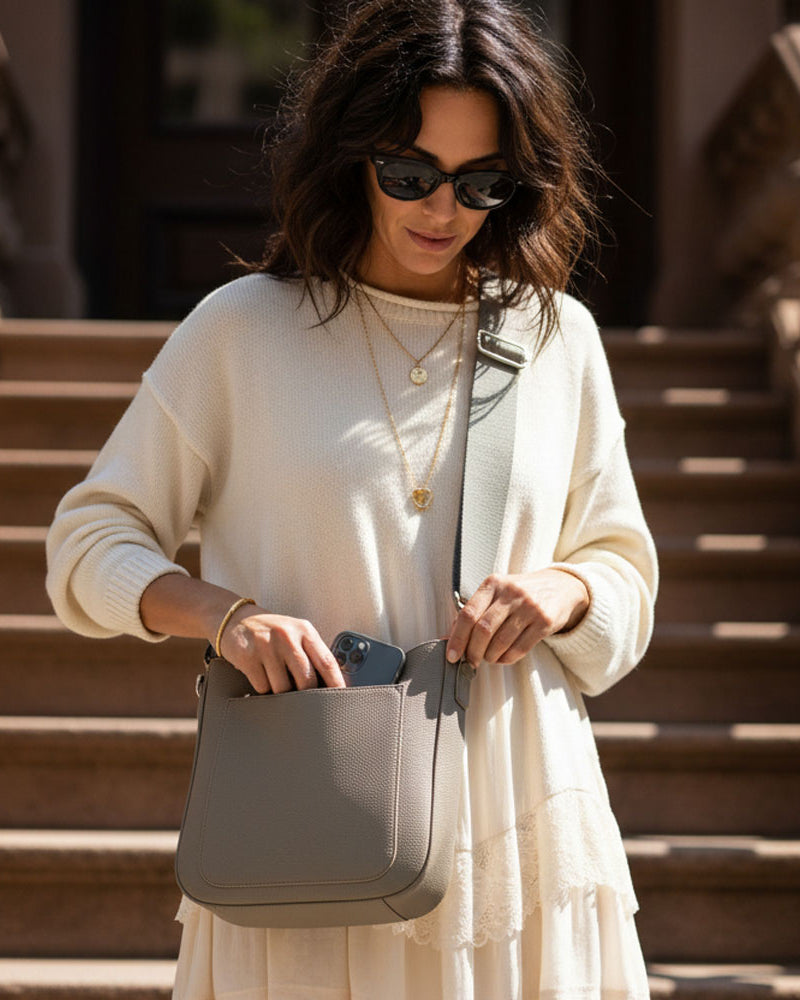 Woman holding a dune handbag on a staircase