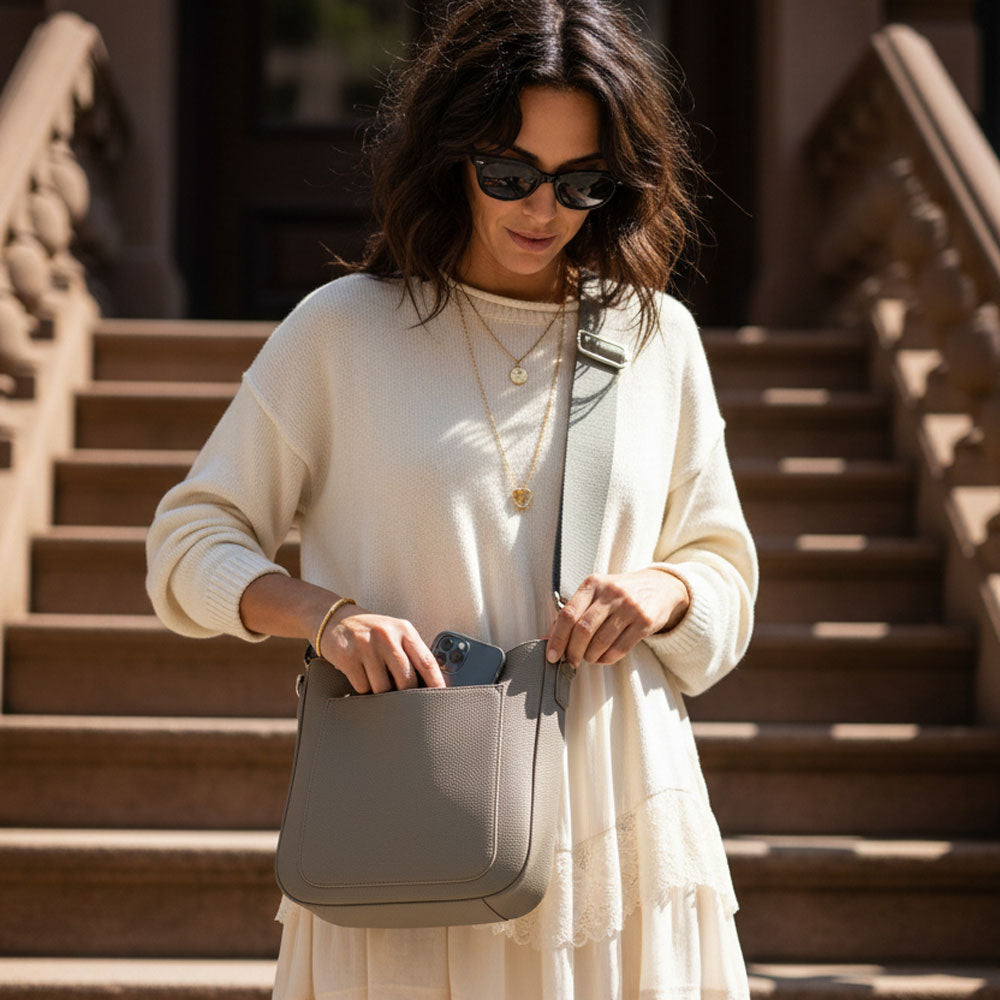 Woman holding a dune handbag on a staircase