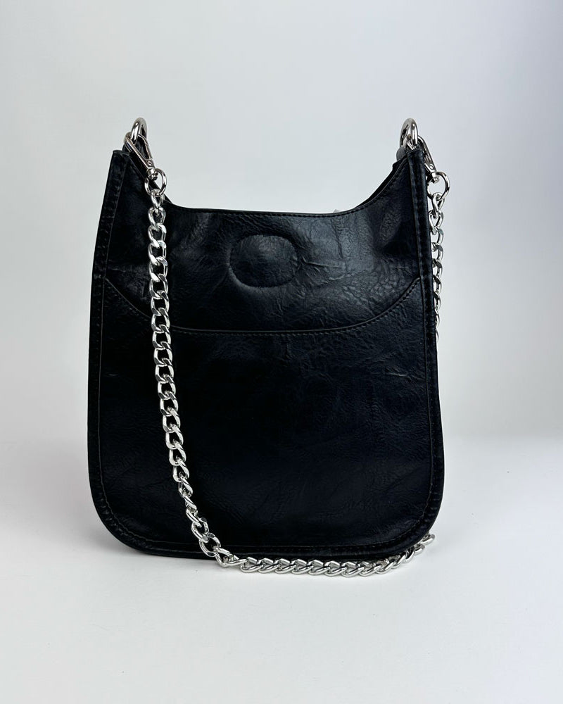 Black Handbag with silver metal chain bag strap on a light grey background