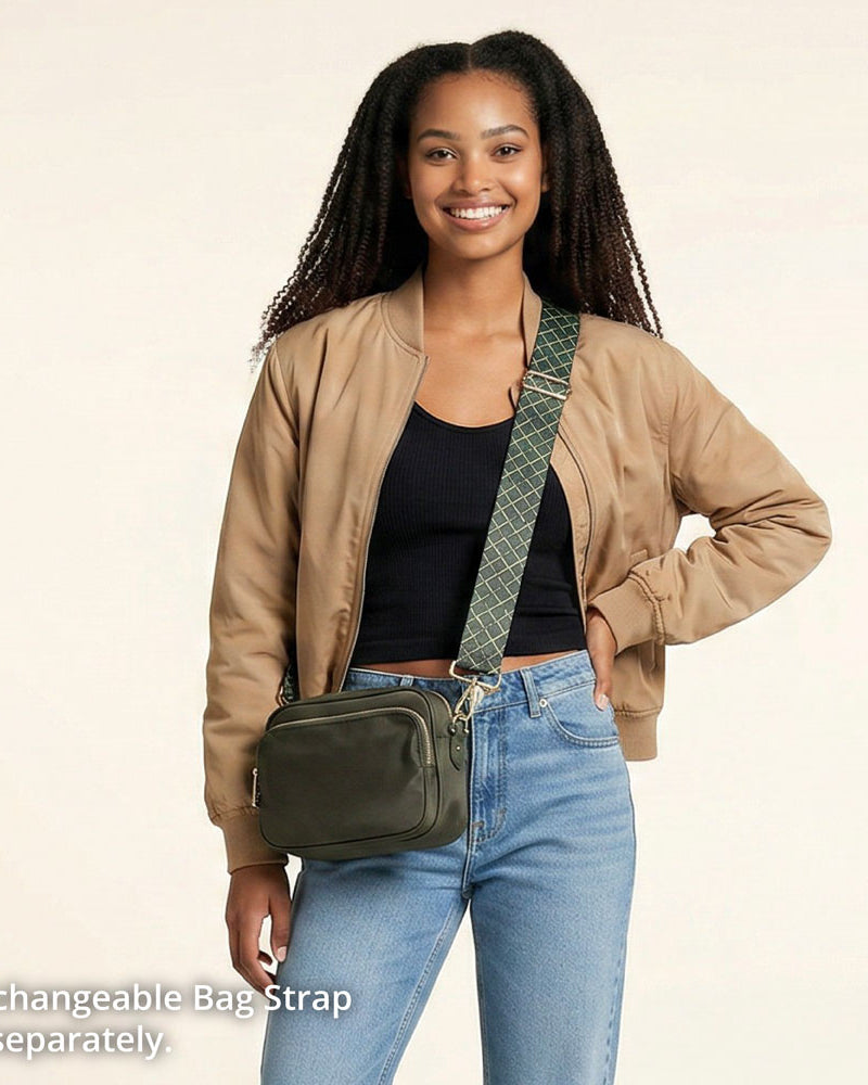 Woman wearing a army crossbody bag with an interchangeable strap on a beige background