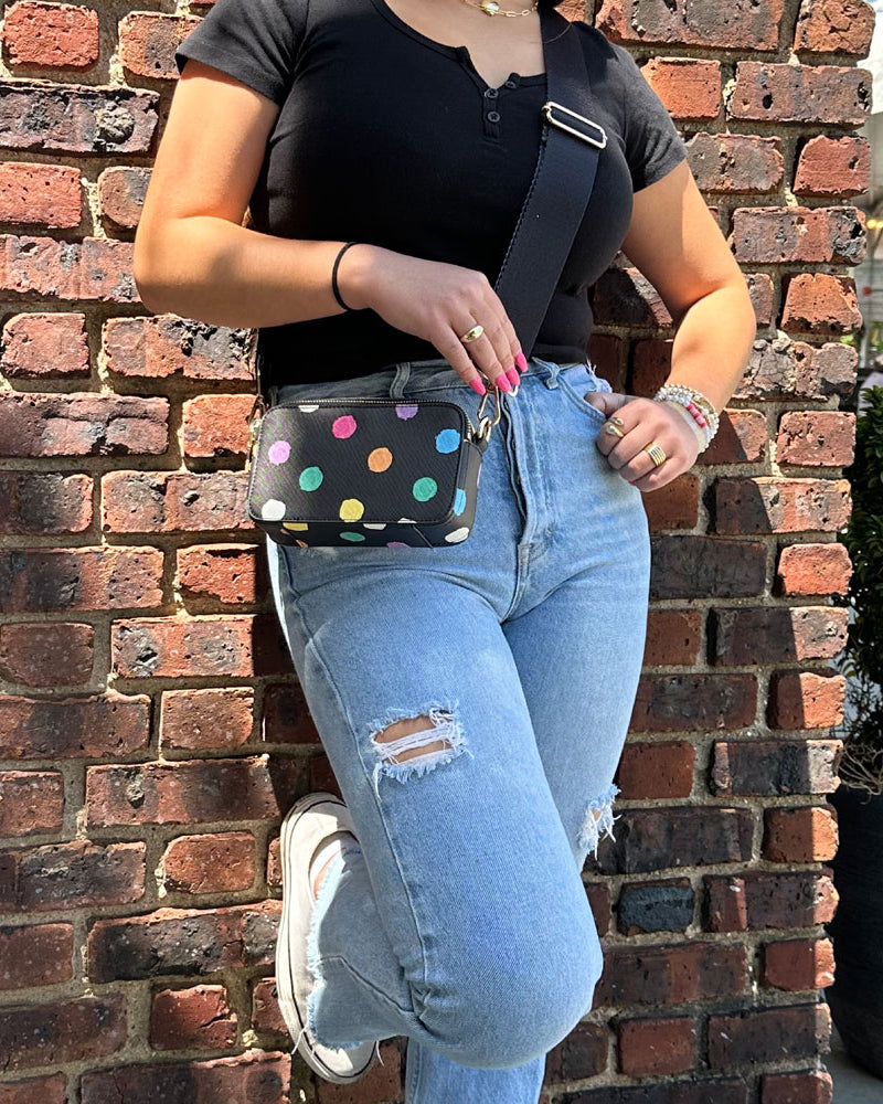 Woman wearing the Jamie Polka Dot Vegan Leather Crossbody in Black with Bright Dots