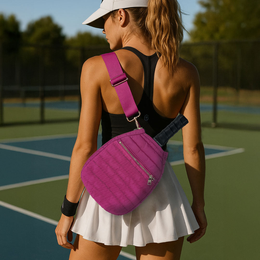 Woman wearing the Pink Poppy Pickleball Bag. Standing on a pickleball court