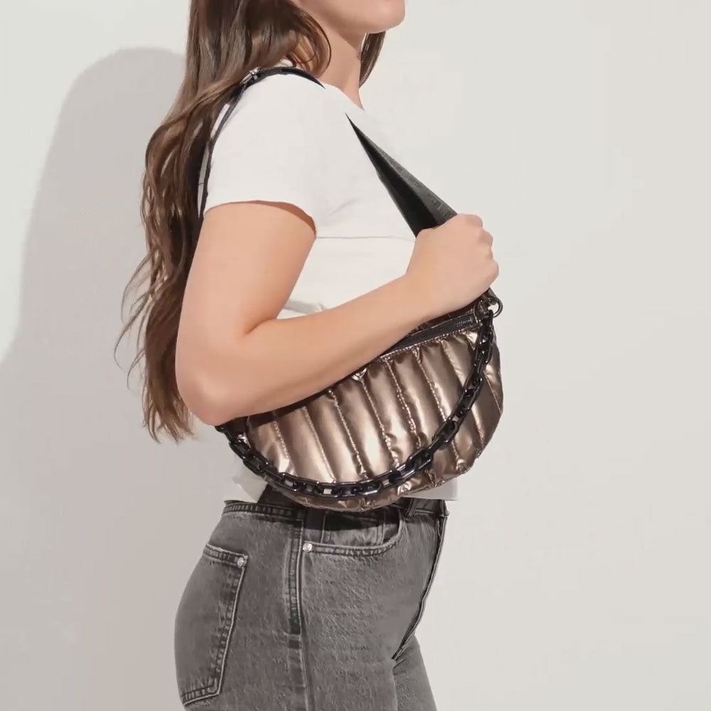 woman wearing the reese quilted nylon sling in bronze on her shoulder