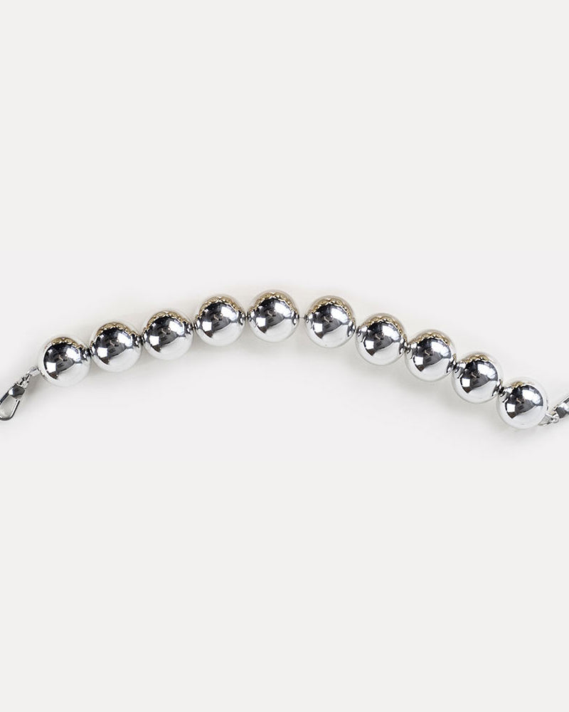 A silver-colored resin bead bag strap.