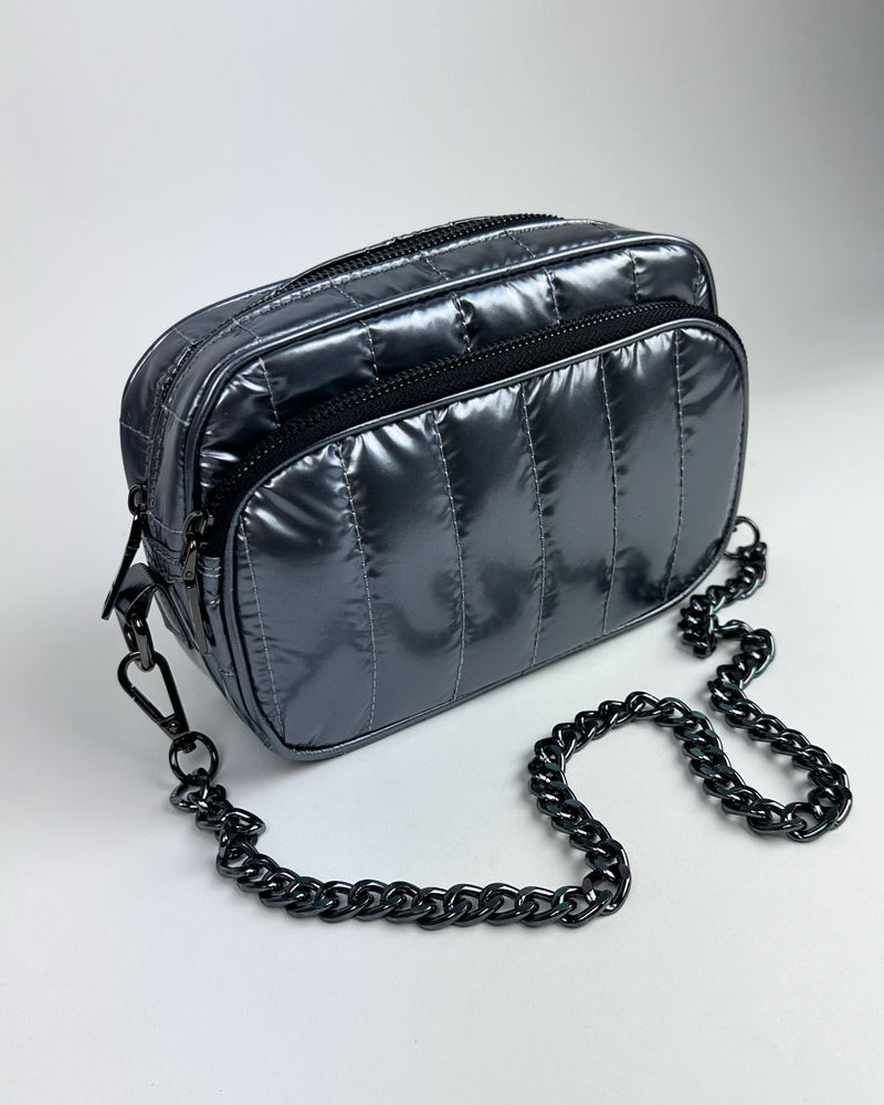 pewter handbag with pewter chain bag strap on a light grey background