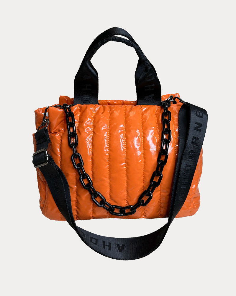 Rosie Quilted Nylon Tote in Orange, shown with resin chain and black adjustable strap