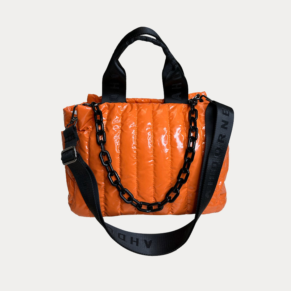 Rosie Quilted Nylon Tote in Orange, shown with resin chain and black adjustable strap