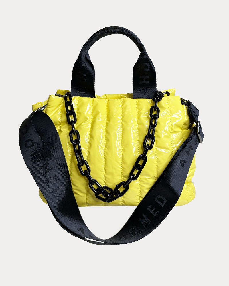 Rosie Quilted Nylon Tote in Yellow, shown with resin chain and black adjustable strap