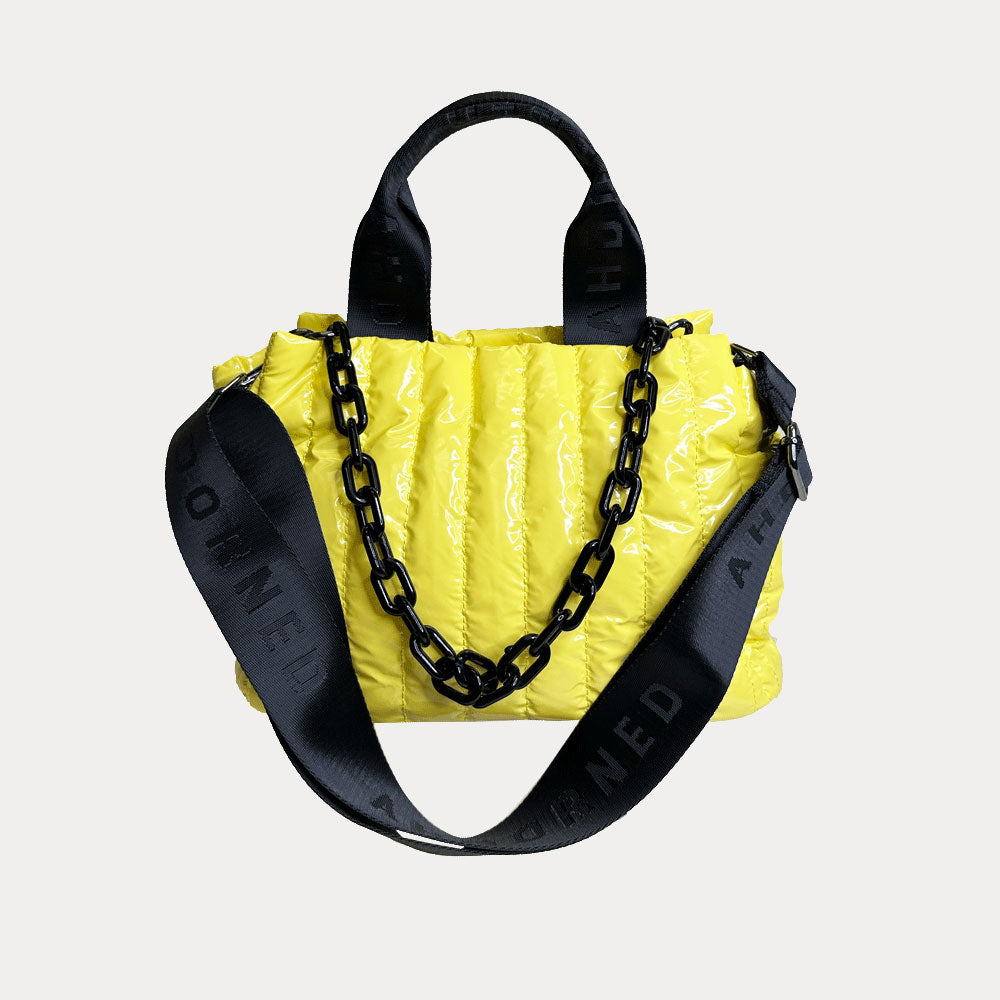 Rosie Quilted Nylon Tote in Yellow, shown with resin chain and black adjustable strap
