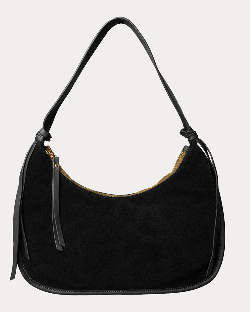 Black vegan suede handbag on a light gray background