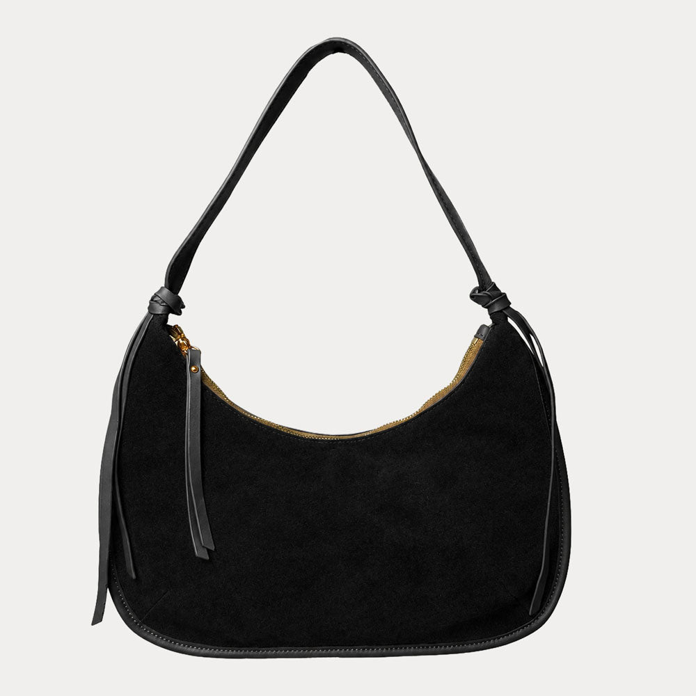 Black vegan suede handbag on a light gray background