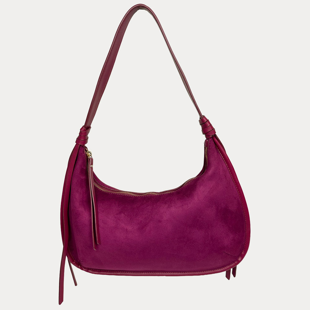 A burgundy vegan suede shoulder bag with a vegan leather details, shown against a light gray background.