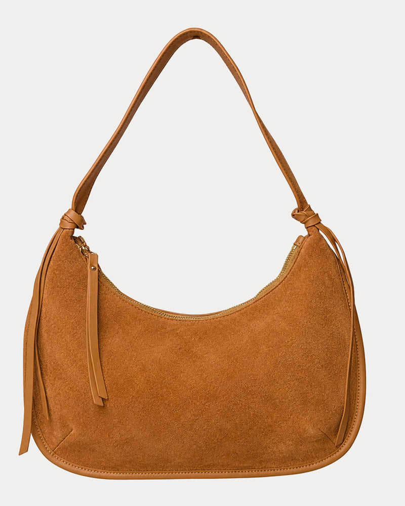 Camel vegan suede handbag on a light gray background