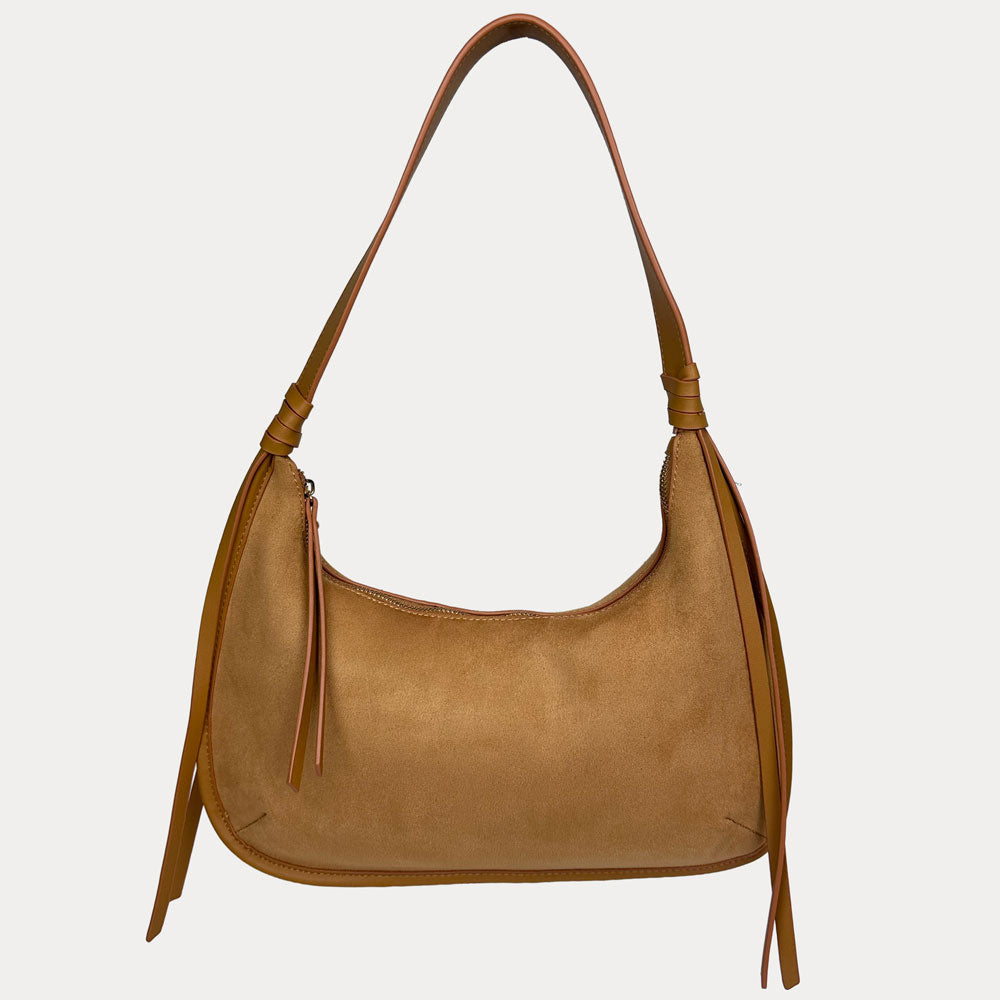 A camel vegan suede shoulder bag with a vegan leather details, shown against a light gray