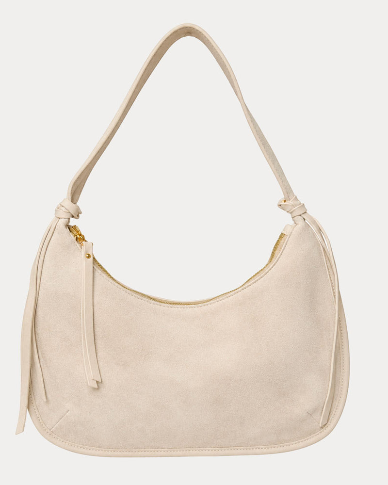 Cream vegan suede handbag on a light gray background