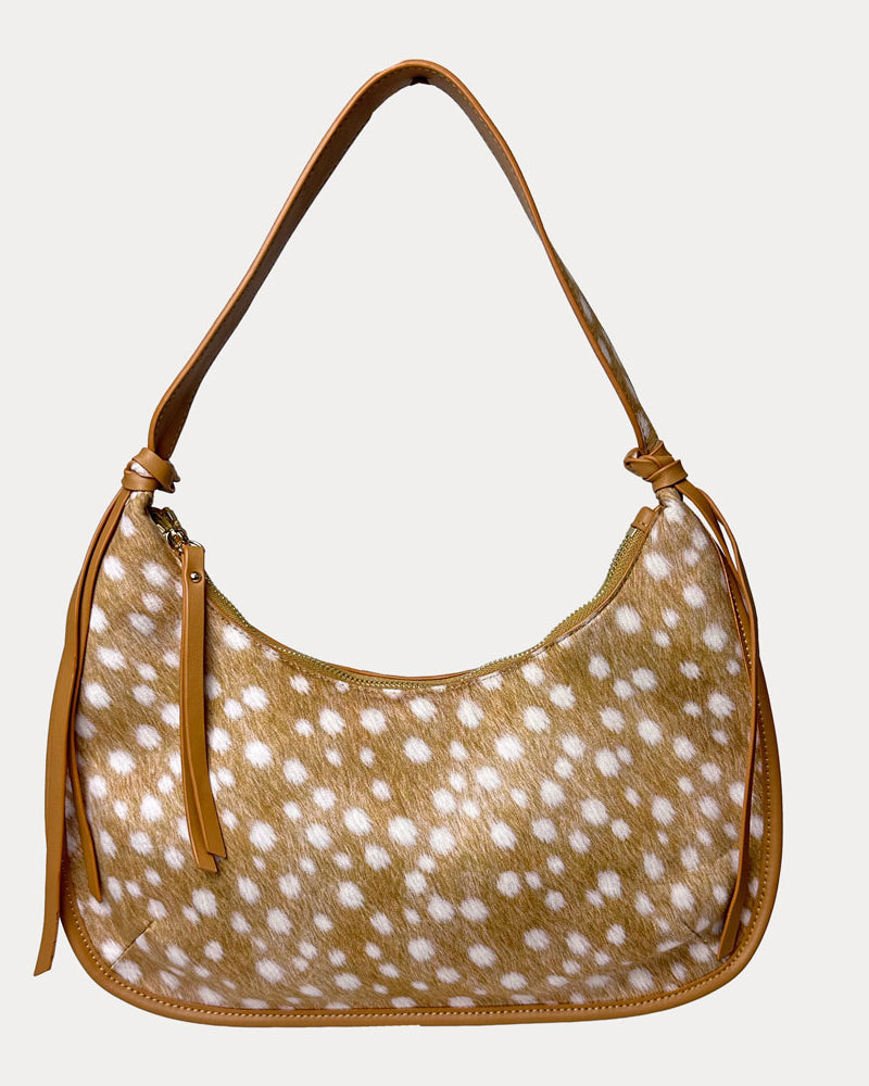 Handbag with deer pattern vegan suede and camel vegan leather details on a beige background