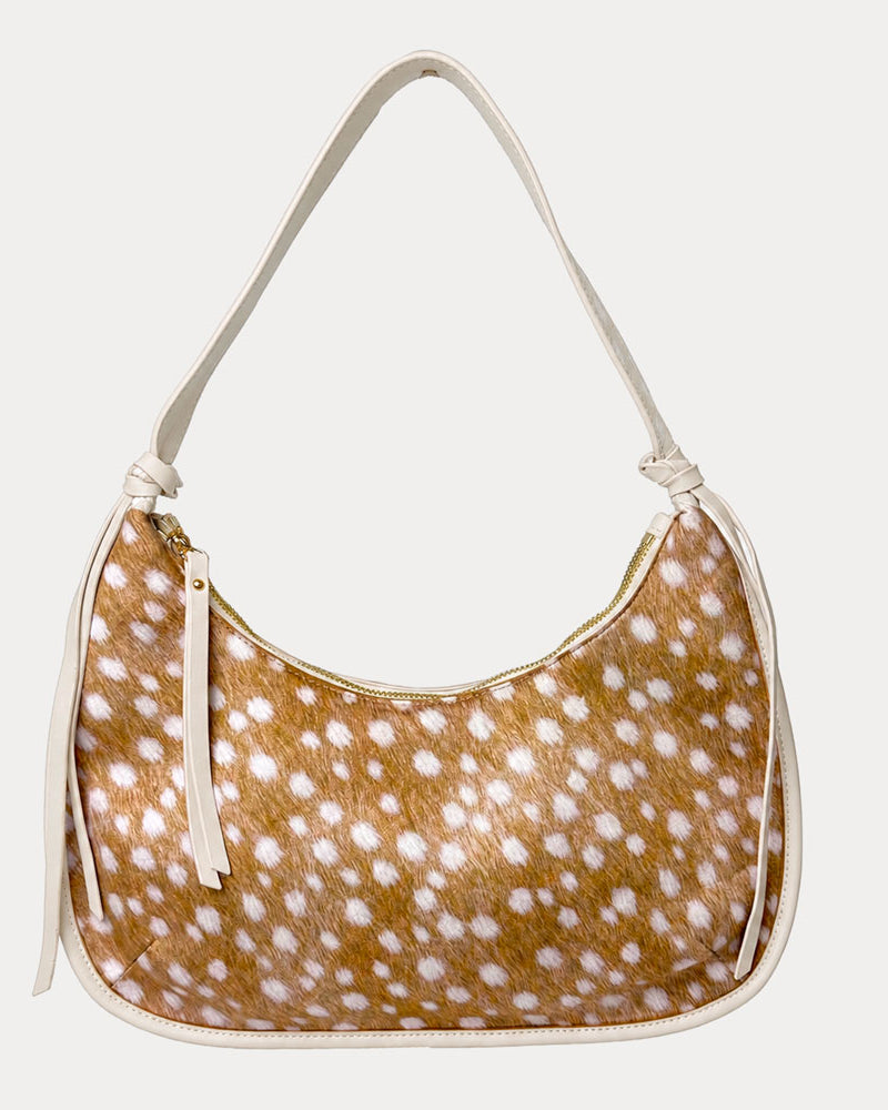 Handbag with deer pattern vegan suede and cream vegan leather details on a beige background