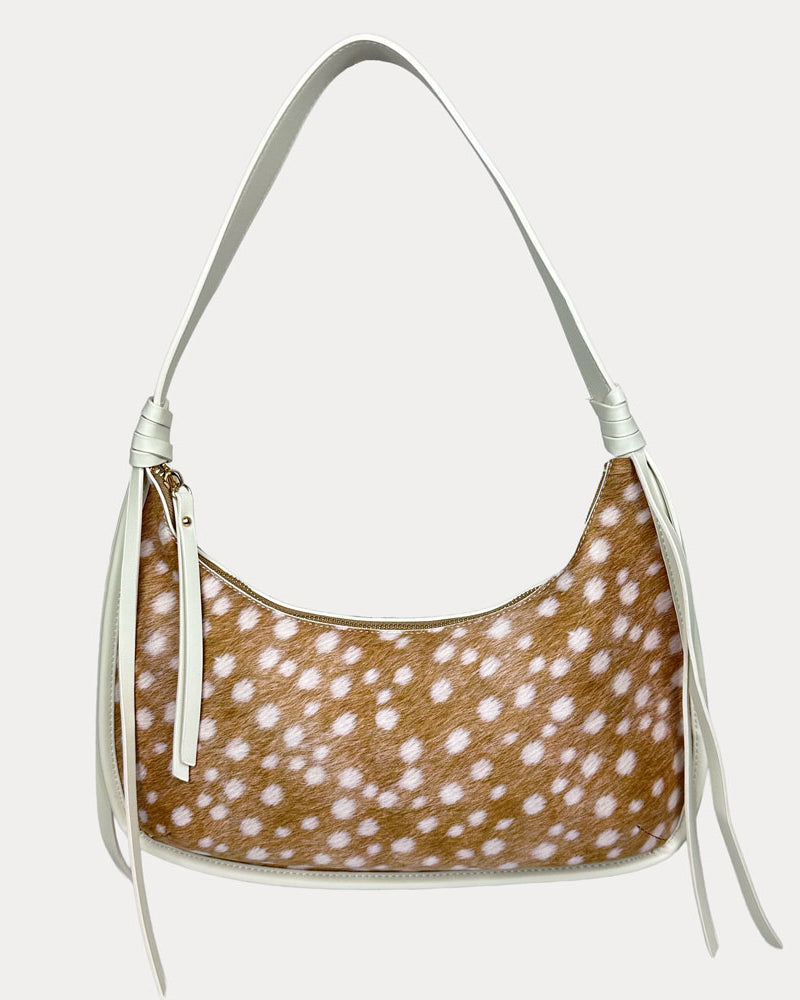 Handbag with deer pattern with cream vegan leather details on a light gray background
