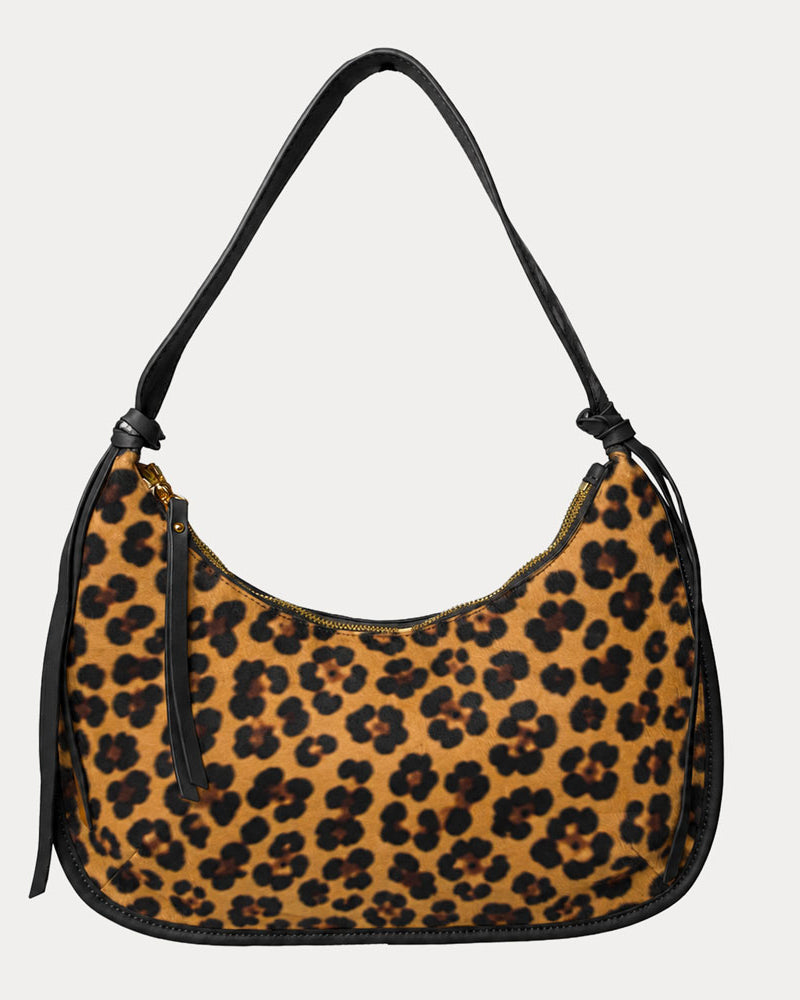 Handbag with leopard pattern vegan suede and black vegan leather details on a beige background