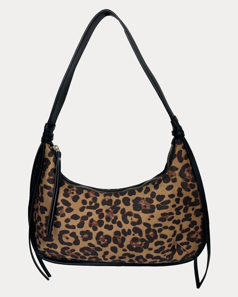 Leopard print handbag with black handle on a light gray background