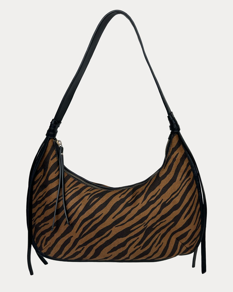 Handbag with tiger stripe pattern on a light gray background