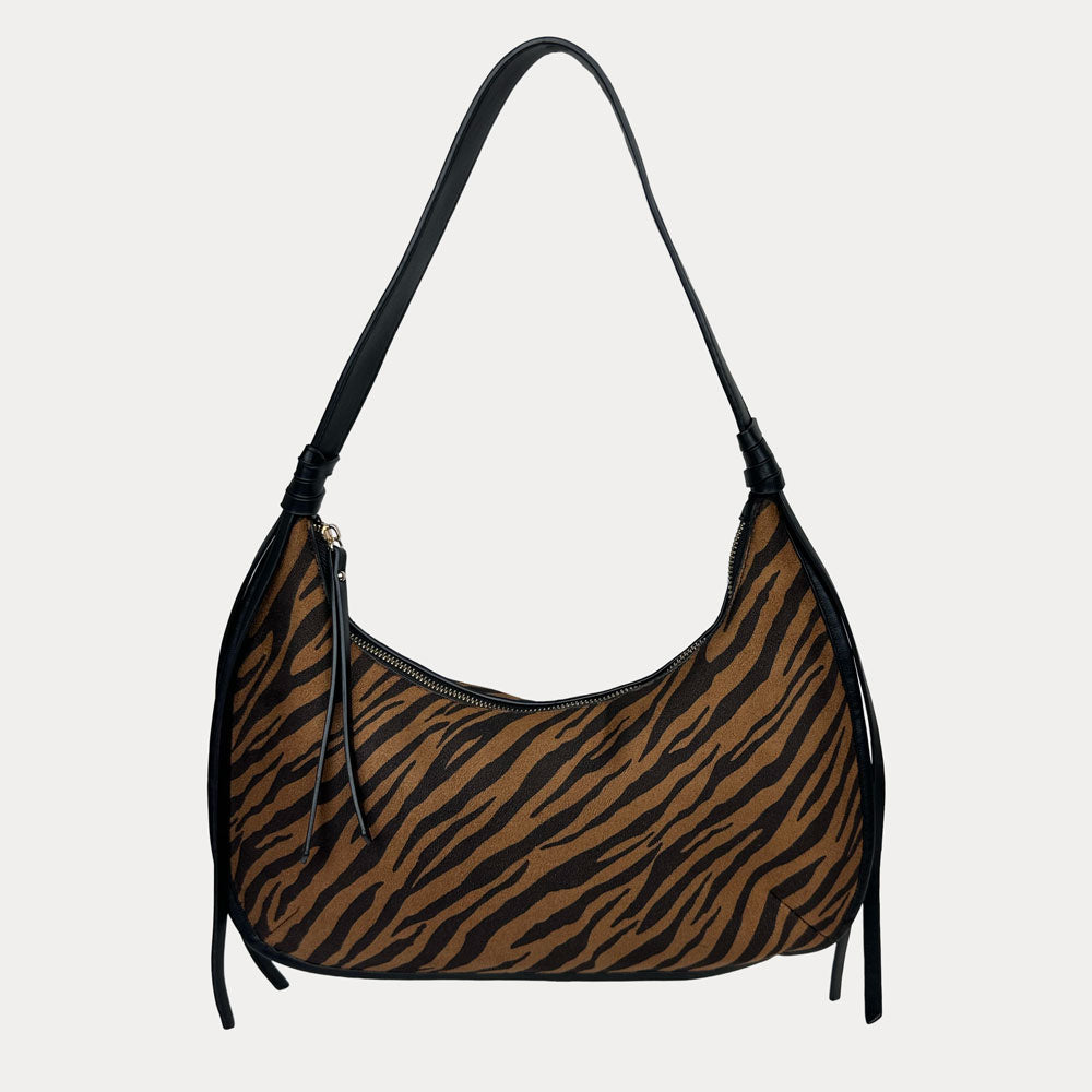 Handbag with tiger stripe pattern on a light gray background
