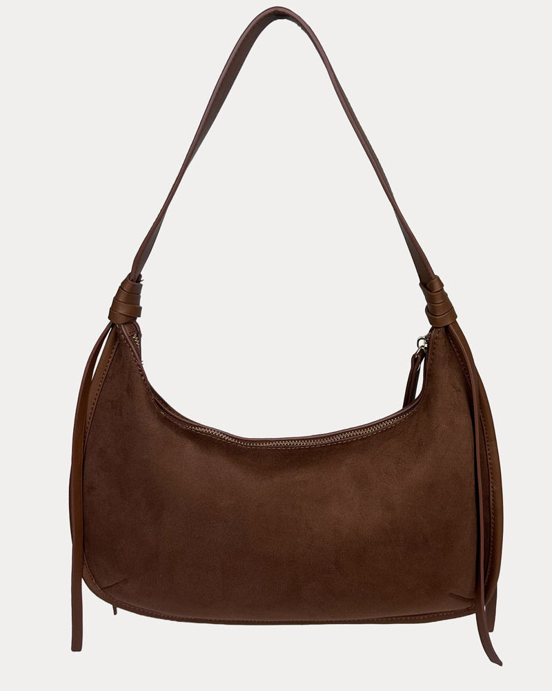 A chocolate shoulder bag with a strap and decorative side tassels, shown against a light gray background.
