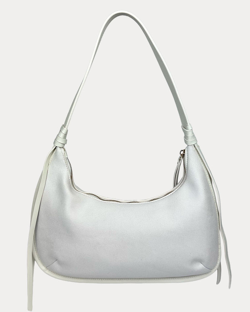 A cream vegan suede shoulder bag with a vegan leather strap, shown against a plain light gray background.