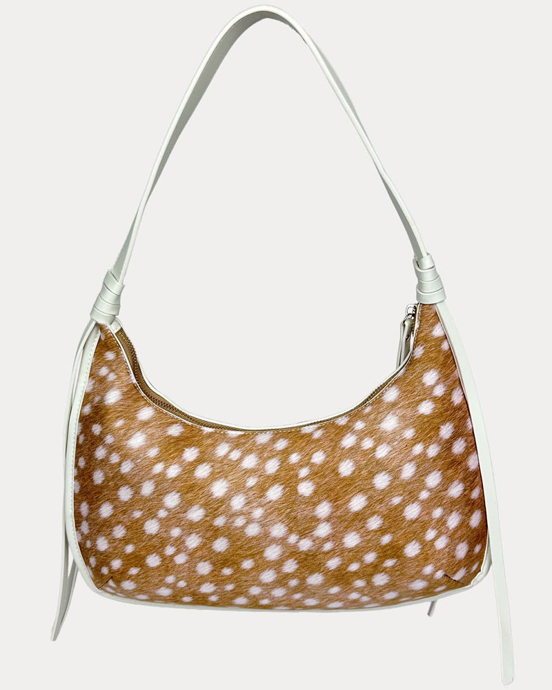 A shoulder bag with a deer animal print body and a cream strap, shown against a plain light gray background.