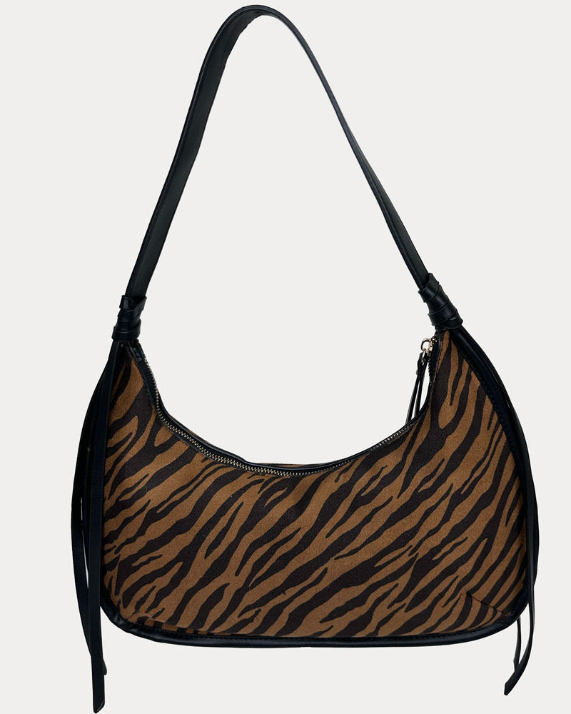 A brown and black zebra-print shoulder bag with black vegan leather shoulder strap, shown against a light gray background.