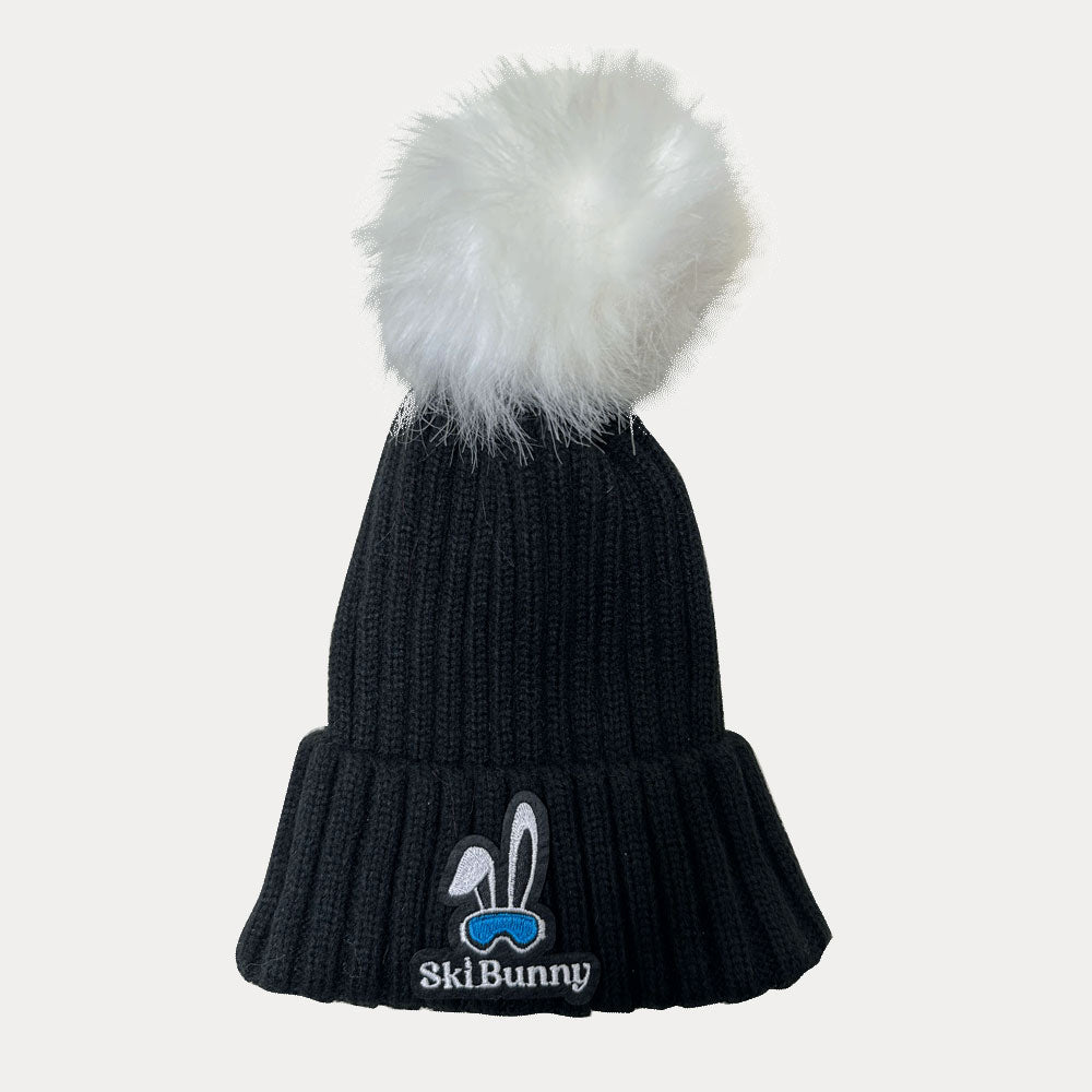 Black ski bunny hat with white pom pom and blue moon ski bunny patch
