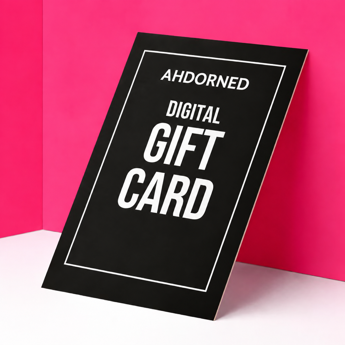 Image of a gift card leaning against a pink wall. 