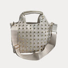 Cream vegan suede toteh with gold studs on a white background