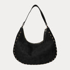 Black vegan suede handbag with studs on a light gray background
